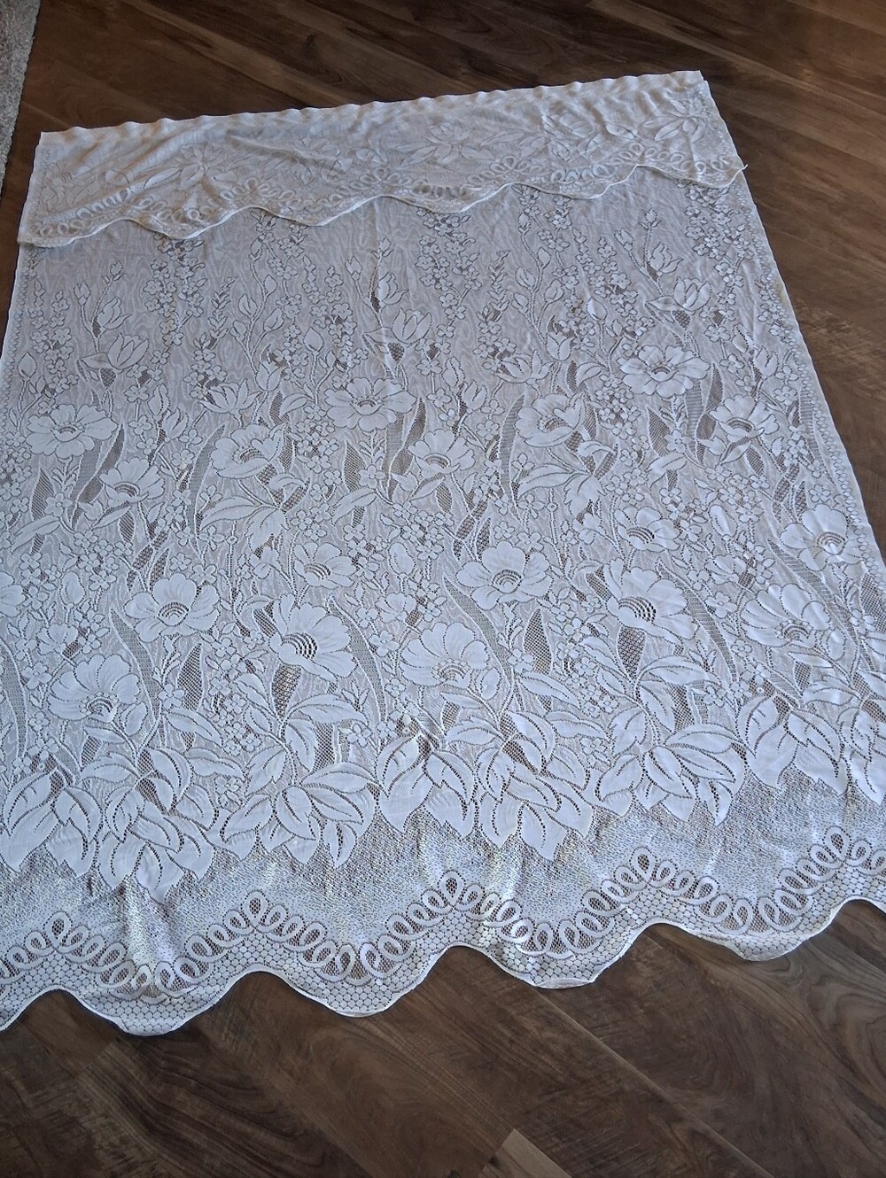 Vintage style floral lace curtain panel featuring an attached scalloped valance.
